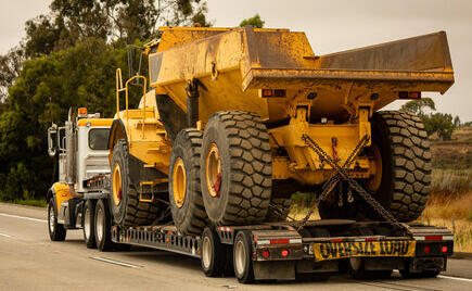 Big yellow truck on an RGN trailer